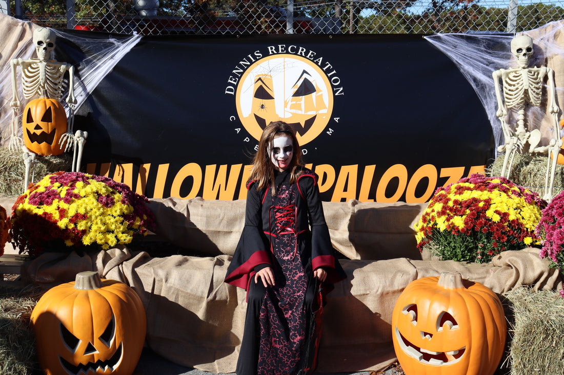 A child dressed as a vampire at the Halloweenpalooza photo backdrop